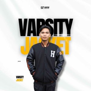 Seorang pria mengenakan jaket varsity berwarna navy dengan lengan satin, menampilkan detail bordir huruf 'H' putih di dada dan aksen garis oranye pada kerah dan manset. Latar belakang putih dengan teks grafis "VARSITY JACKET